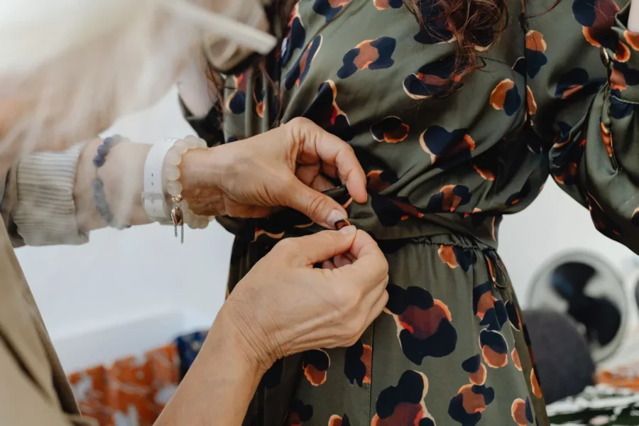 Fashion designer adjusting dress