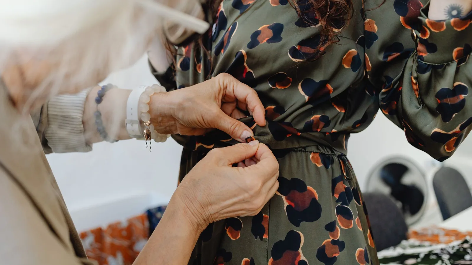 Fashion designer adjusting dress