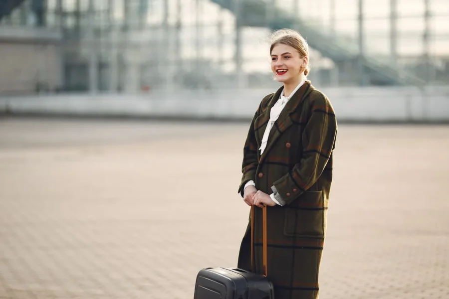 Happy woman airport travel outfit
