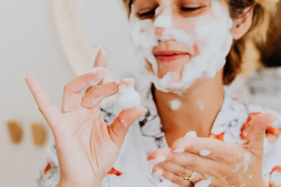 Happy woman skincare cleansing bathroom