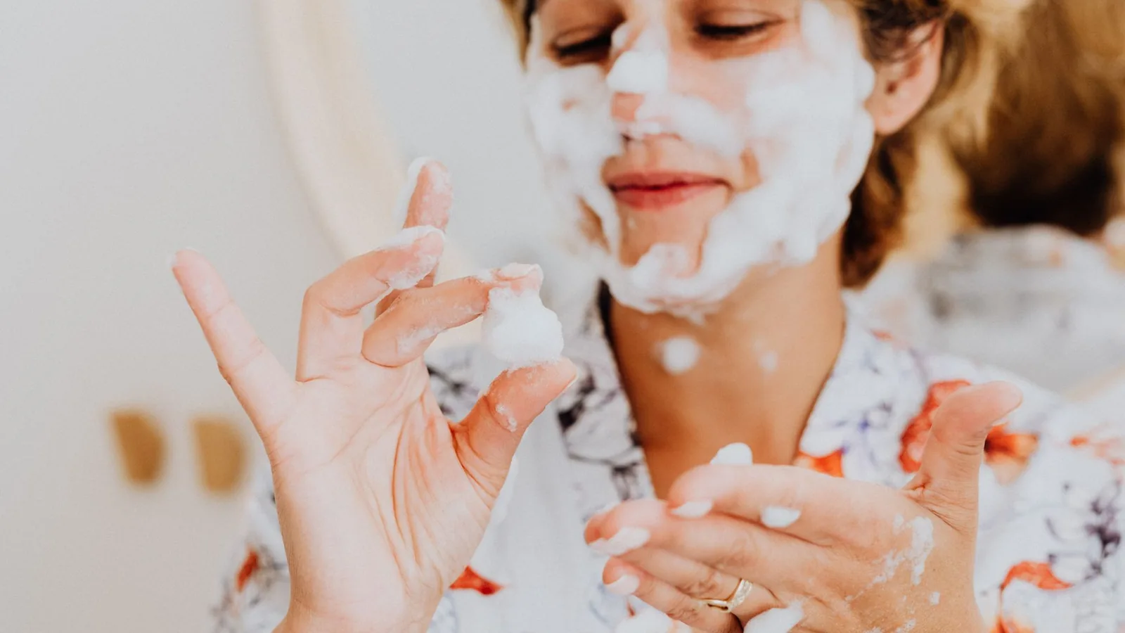 Happy woman skincare cleansing bathroom