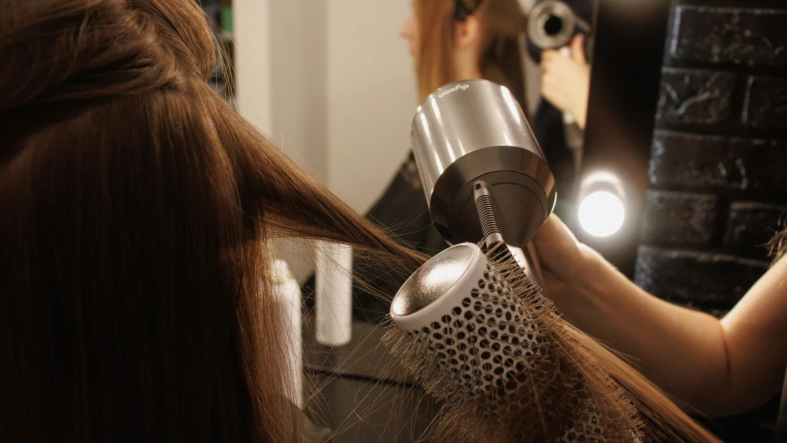 Woman drying hair bright modern room