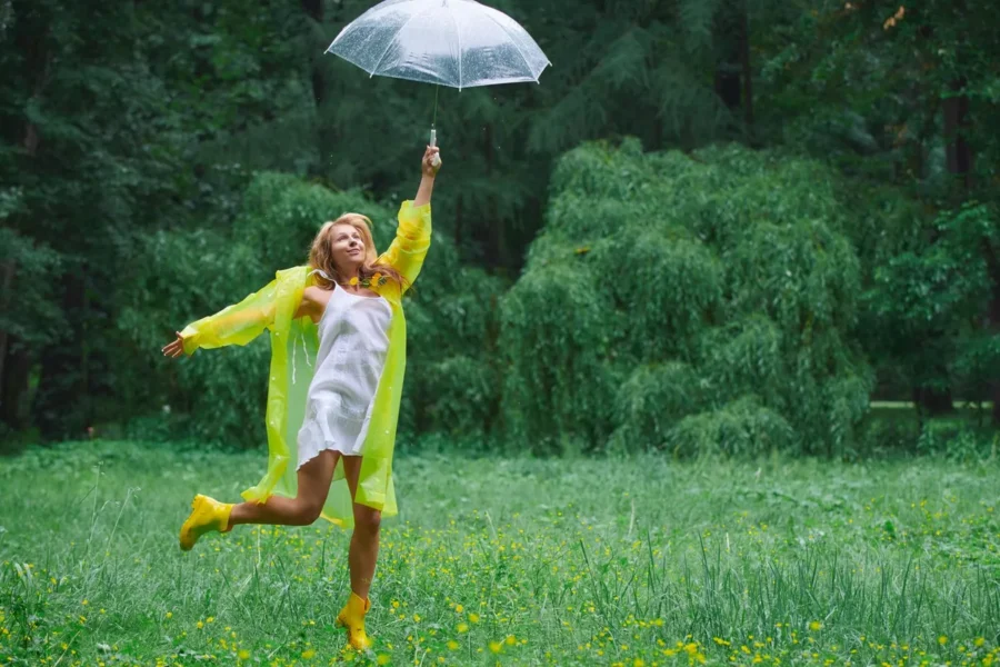 Joyful woman countryside raincoat